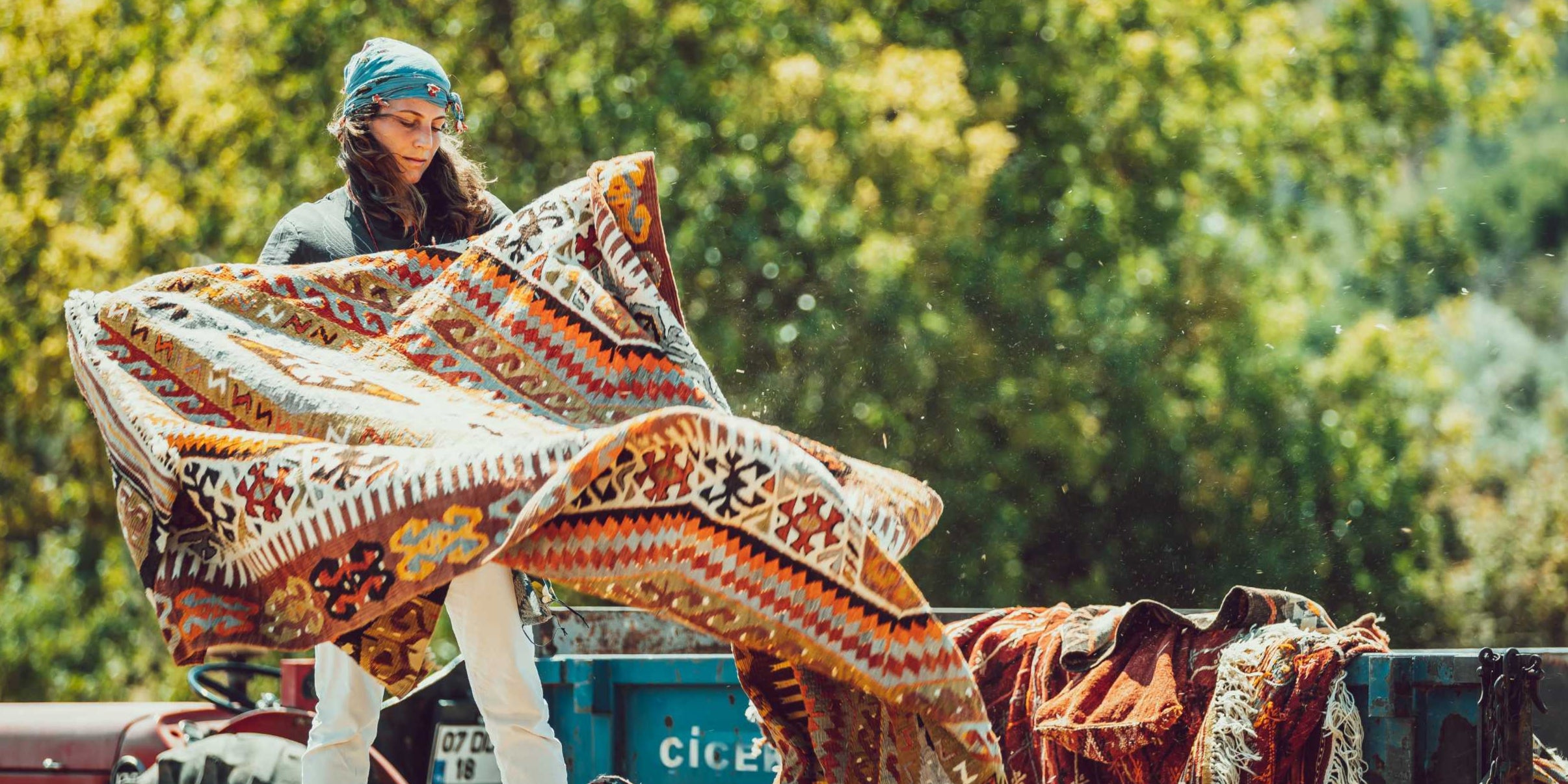 Woman with Vintage Kilim Rug in her hands