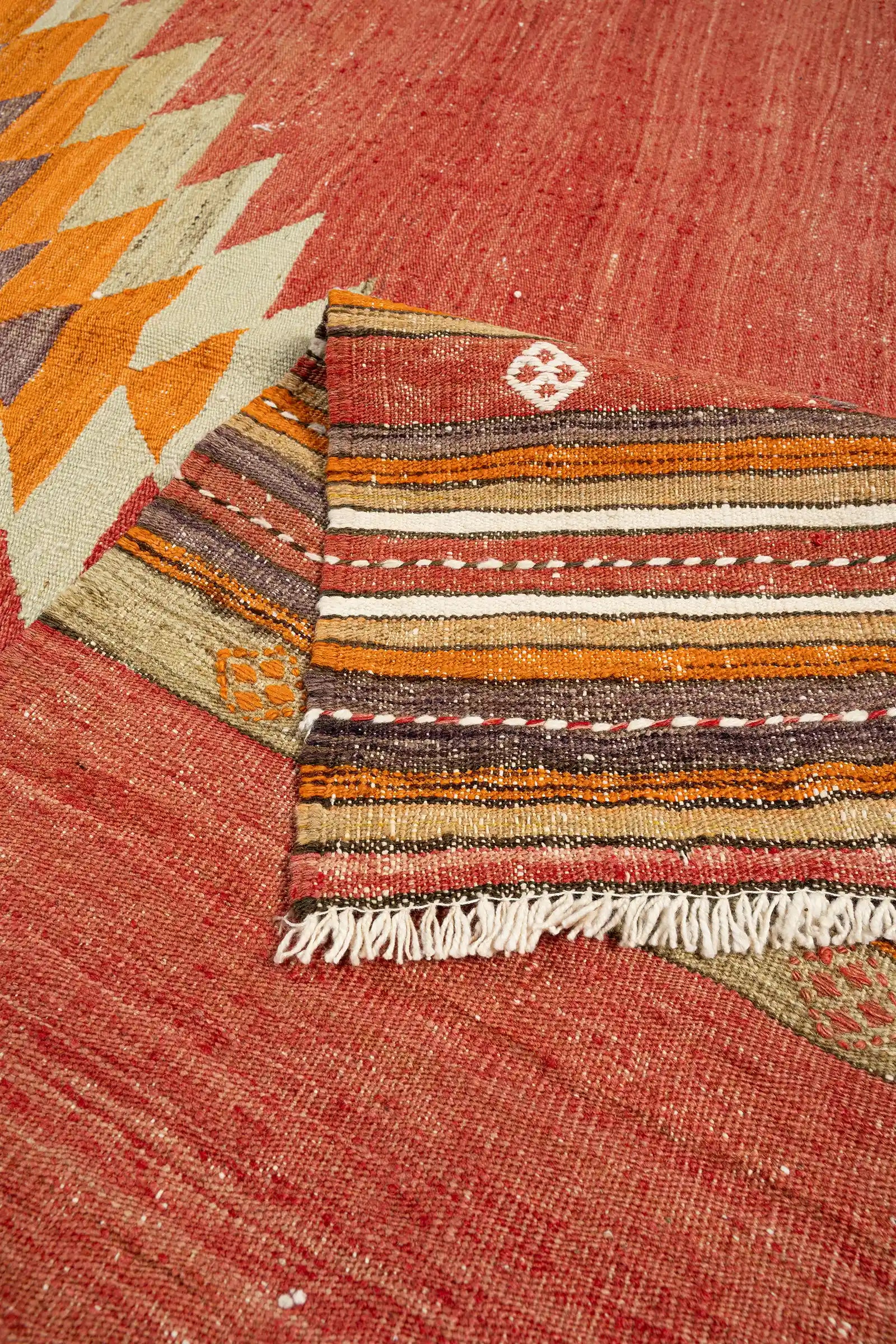 Vorder- und Rückseite des Kilims nebeneinander – geflochtene Fransen, originale Rückseite und leichte Alterungsspuren